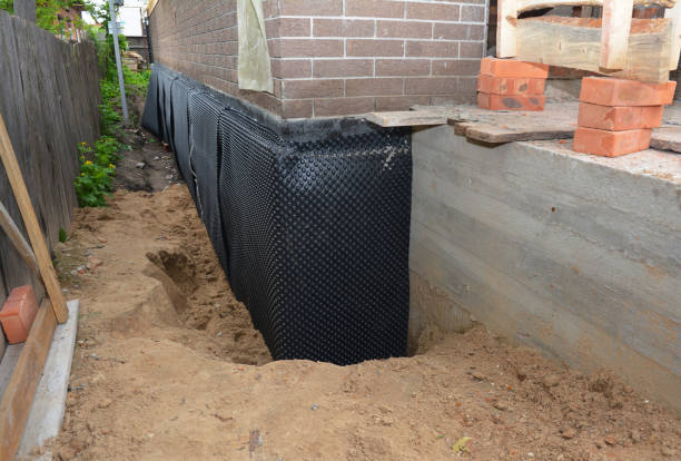 Happy homeowners after waterproofing job in Romney